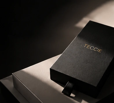 A black TECCIE presentation box with gold lettering.